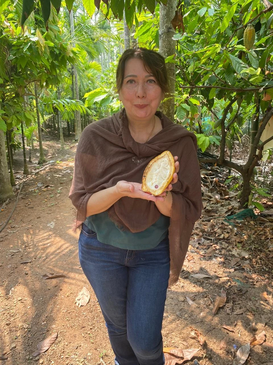 Liliya holding a freshly opened cacao pod